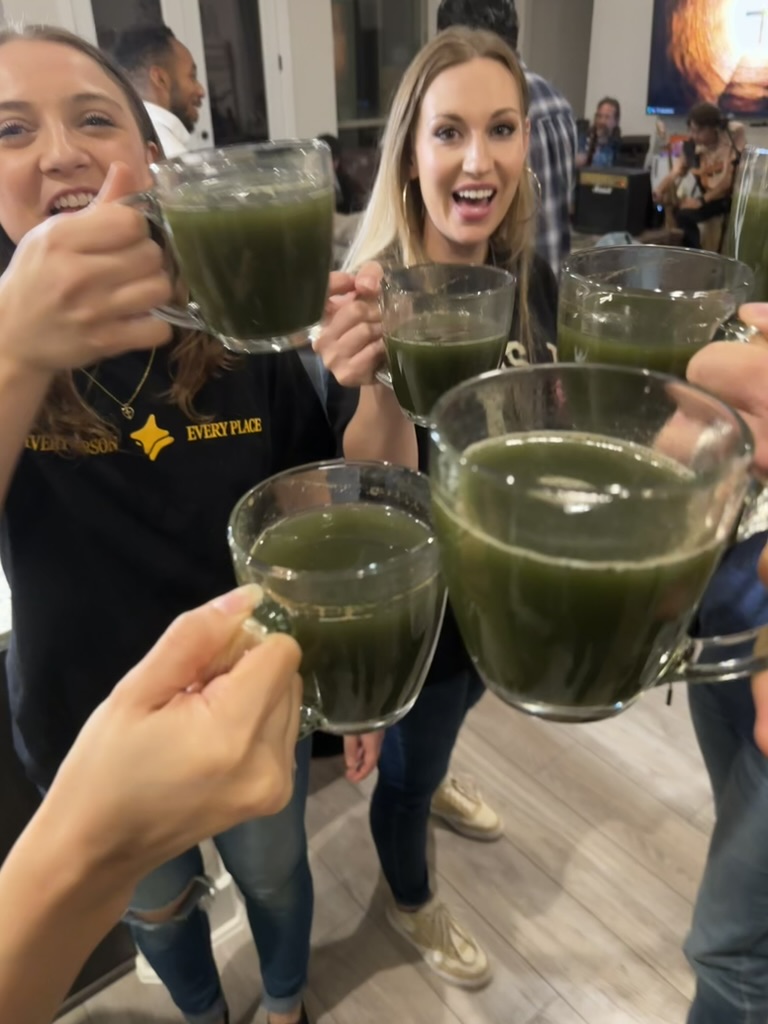 People raising cups during a home gathering